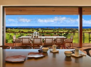 Indoor Outdoor kitchen and deck with cable railing and expansive ocean view.