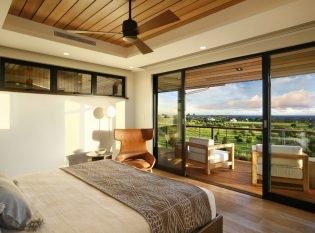 Modern bedroom with glass doors leading to the deck.