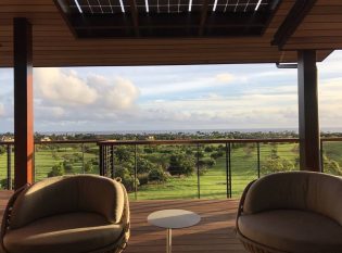 Covered Deck with cable railings an expansive ocean view