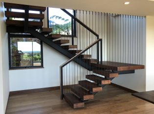 Open Staircase with blackened vertical cables.