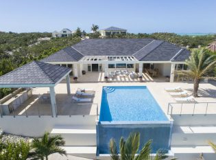 Kitchen cabana, infinity edge pool and aluminum cable railings