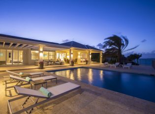 Romantic night lighting reflecting off the infinity edge pool.