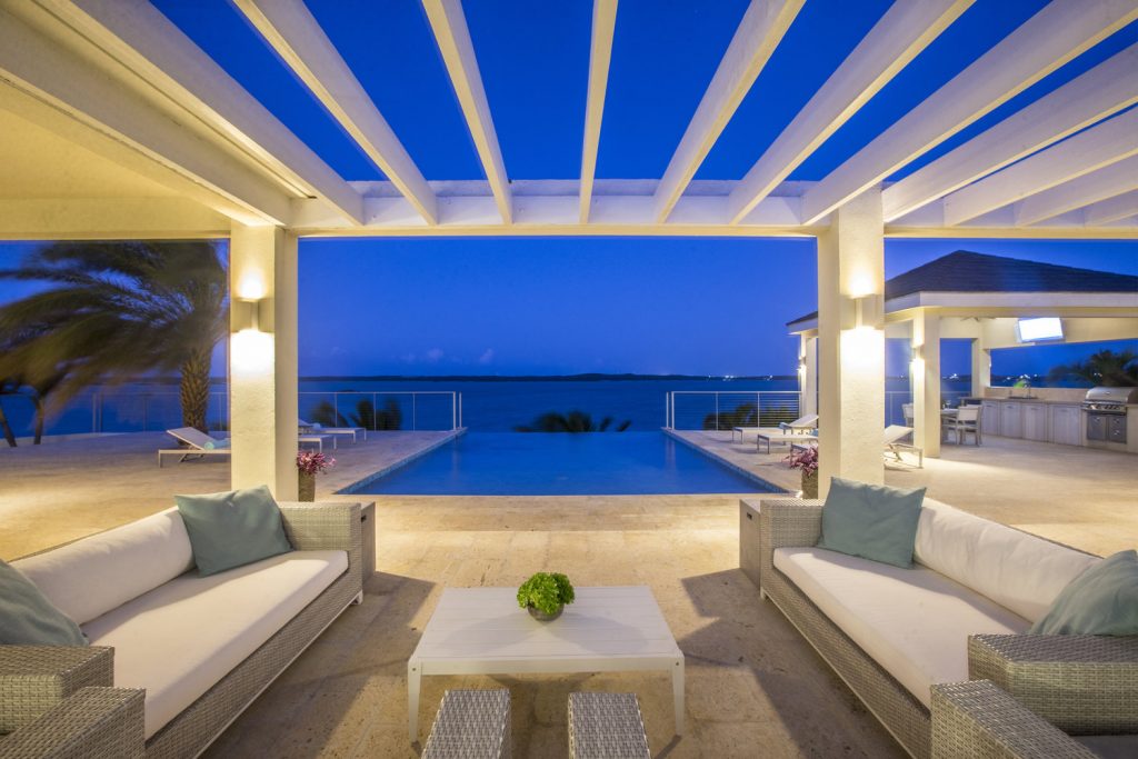 Pool Deck Railing in the background view from the open living space with Pergola night lighting.