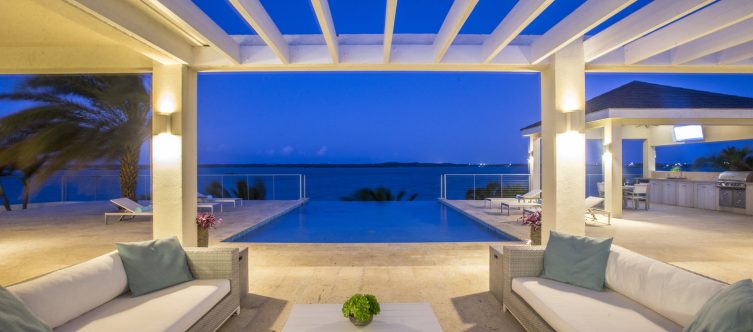 Pool Deck Railing in the background view from the open living space with Pergola night lighting.