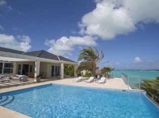 Infinity edge pool deck railing with ocean view.