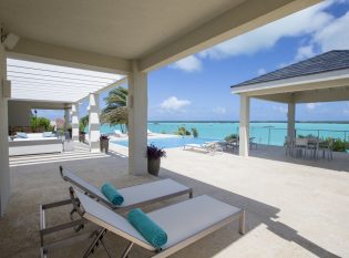 Covered porch with ocean view and cable railings