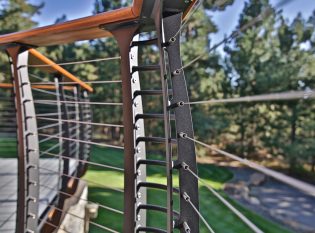 Close up of curved deck railing by Keuka Studios