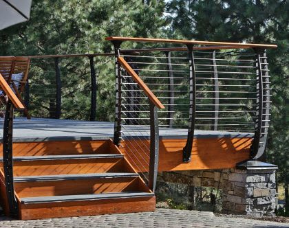 Curved deck railing on log cabin