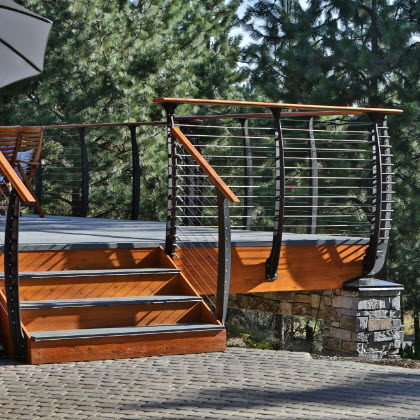 Curved deck railing on log cabin