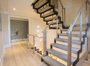 Zig Zag stringers on floating modern staircase with wood treads