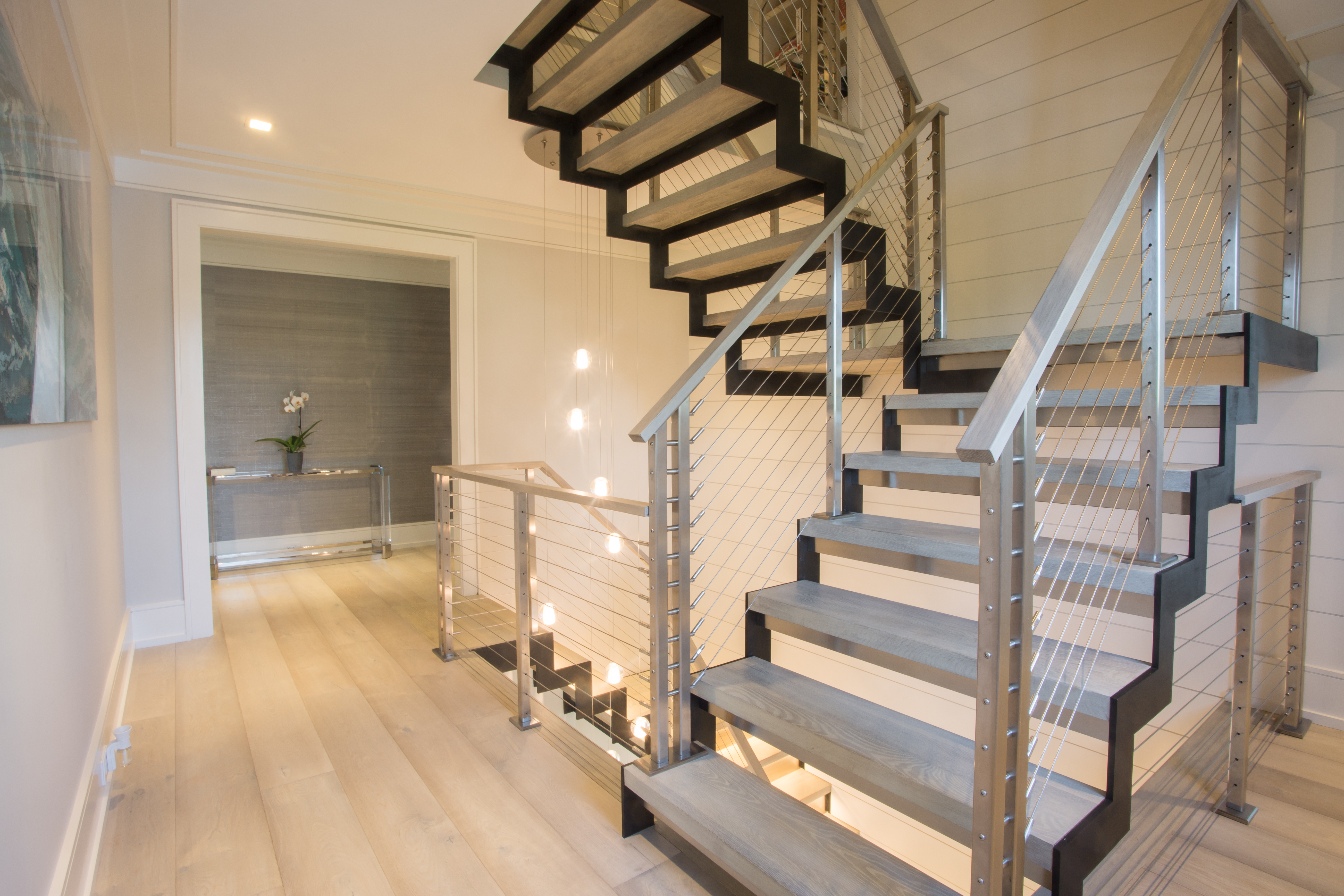 Zig Zag stringers on floating modern staircase with wood treads