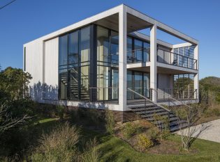 Floor to ceiling glass on a modern cube home in Montauk, NY