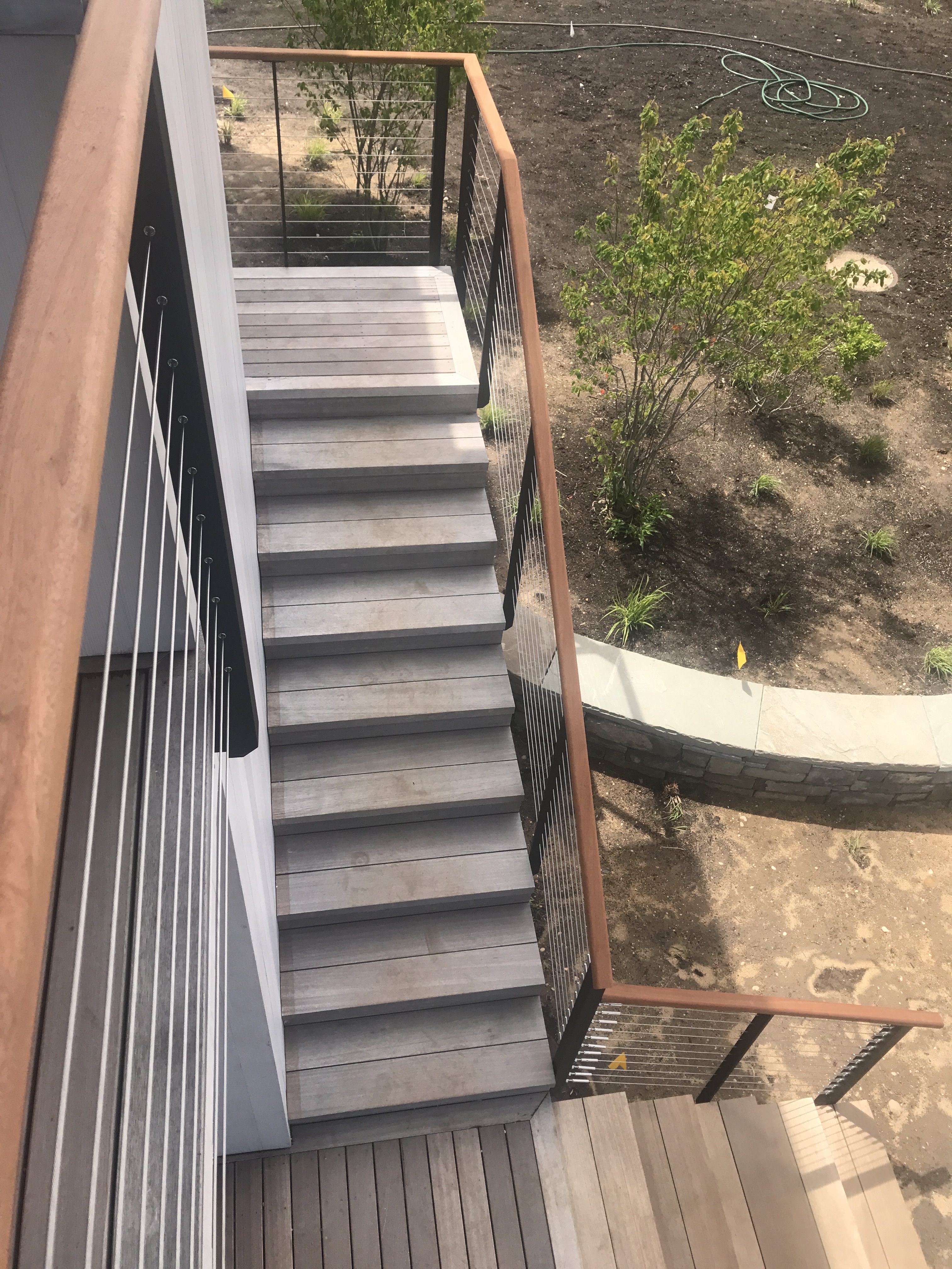 Exterior cable railing with wood top rail