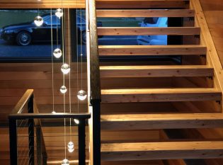 Wood treads on rustic stairs with modern lighting