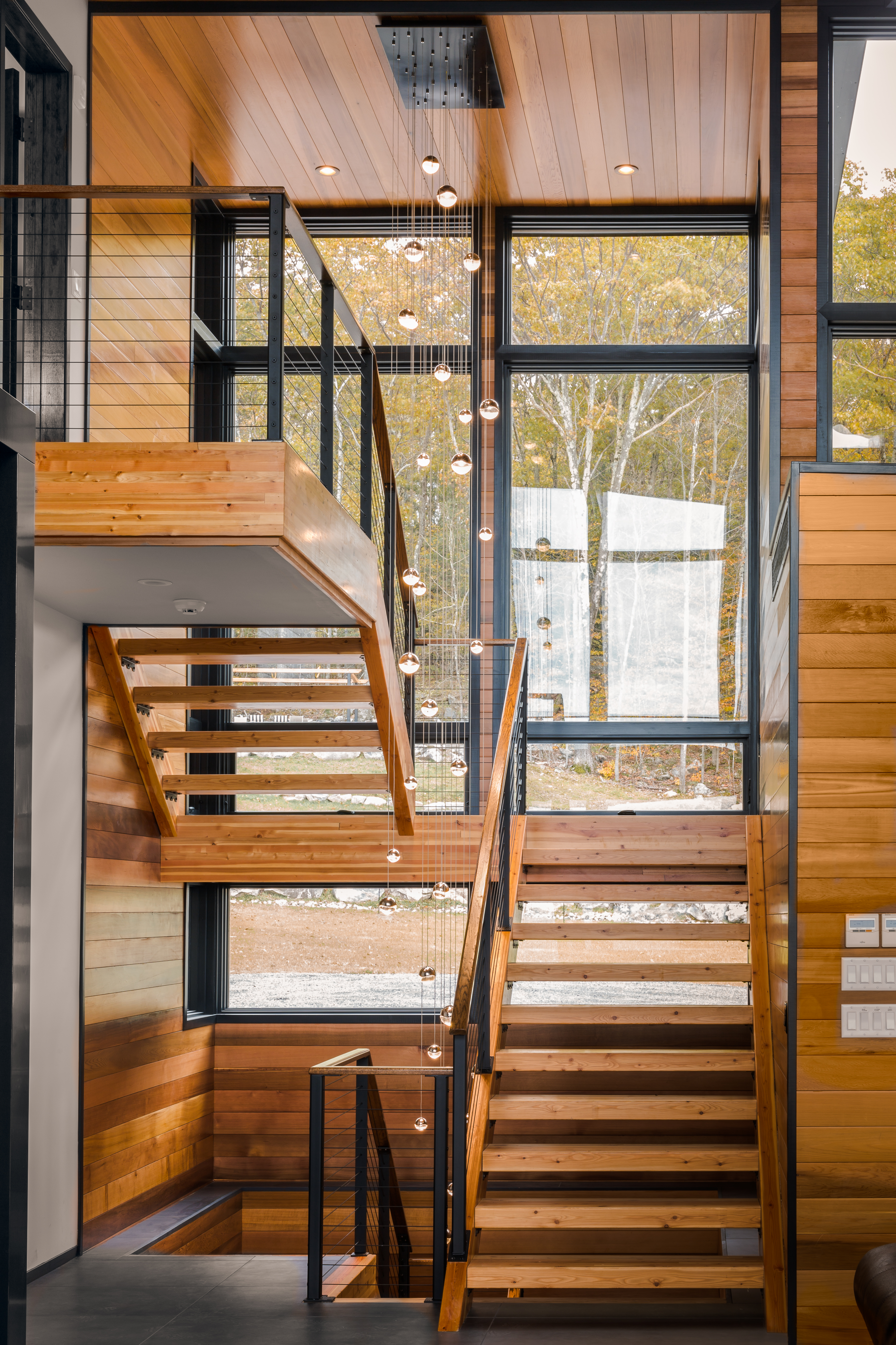 Wood Staircase with black cable rails
