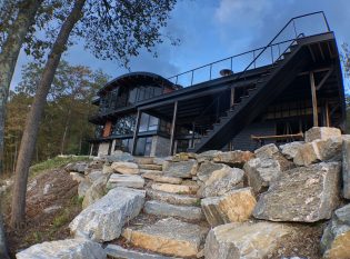 Exterior of rustic modern home with black trim