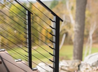 Close up of black cable railing stair fittings 