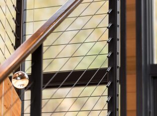 Rustic modern staircase with slim railing posts