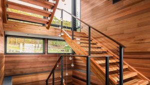 Open-tread stairs with black cable railing