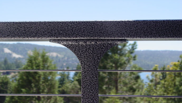 Close up of silver powder-coated post and aluminum top rail