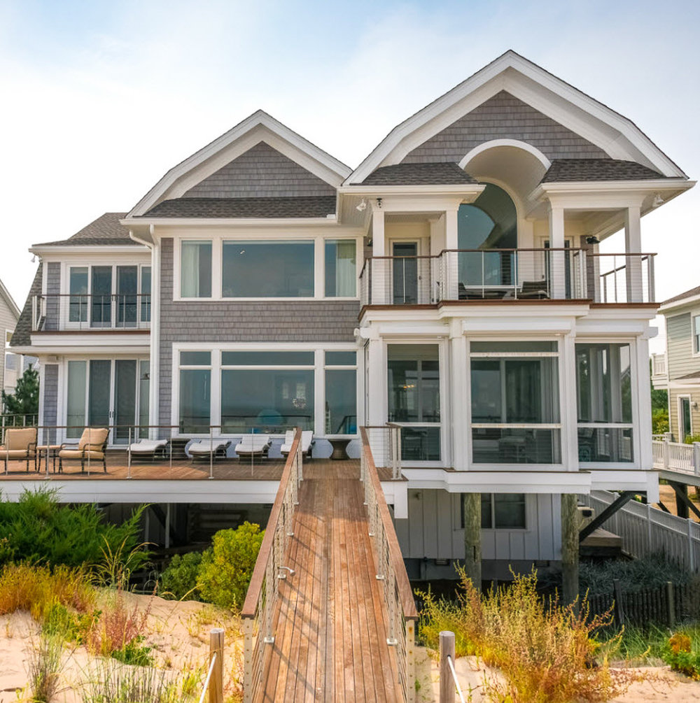 Cable railing on beach house deck and ramp that leads to the sand.