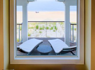 Beach house bathroom with a view of the ocean. 