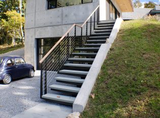 Exterior mono stringer stairs with stone steps