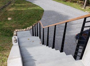 Mono stringer stairs with custom cable railing and stone steps