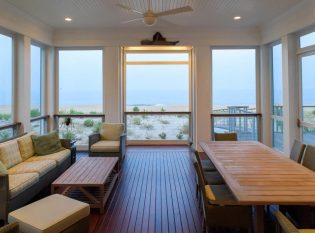 Beachfront screen porch enclosed with Ithaca Style cable railing. 