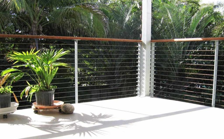 Florida home with open deck surrounded by tropical plants.