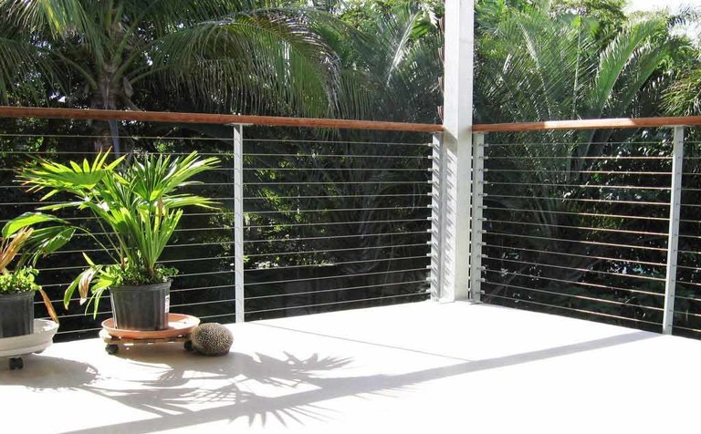 Florida home with open deck surrounded by tropical plants. 