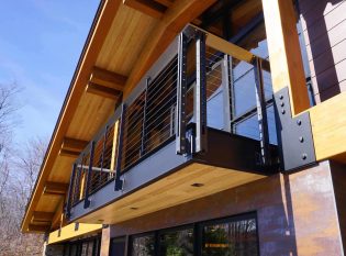 Third-story exterior balcony with fascia-mounted cable railing