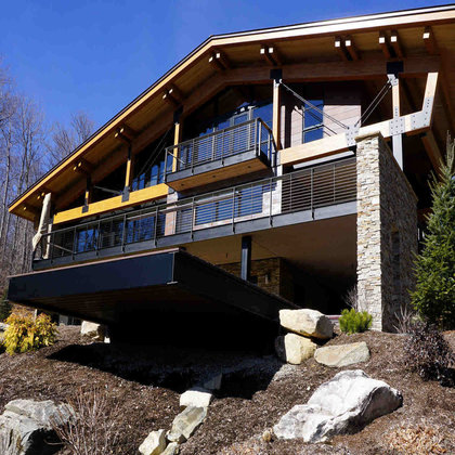 Exterior of Vermont mountain home with cable railing on deck and balcony