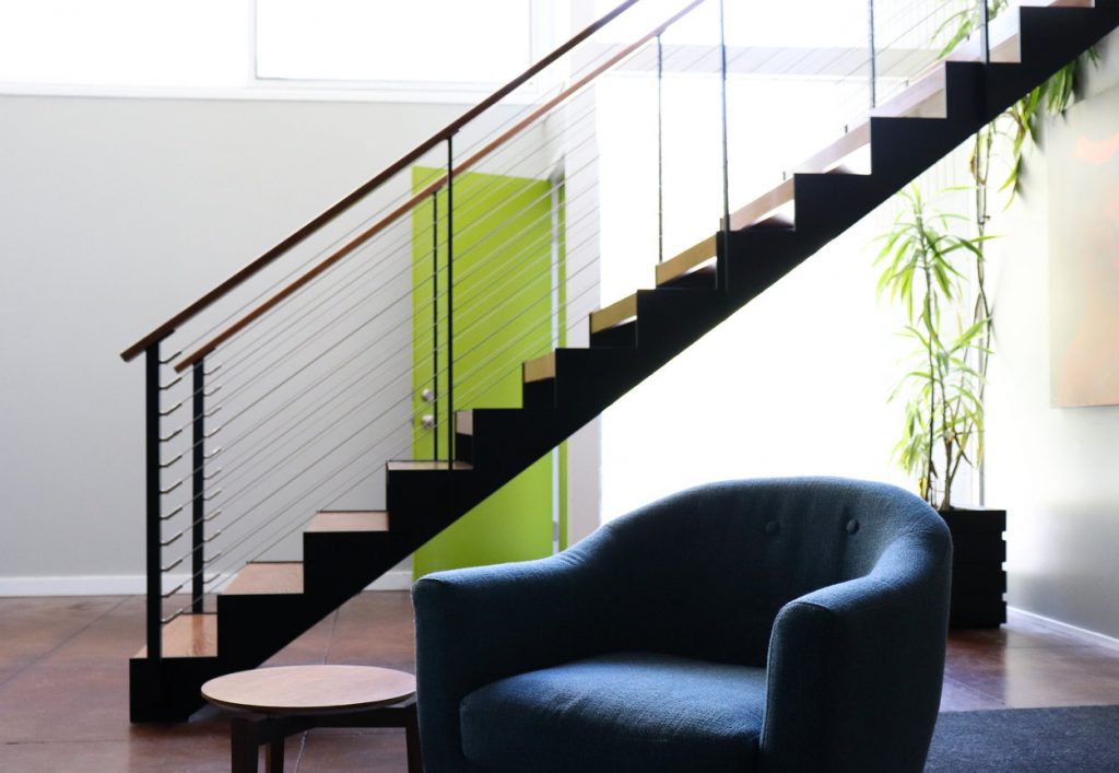 Mid-century modern furniture and floating staircase