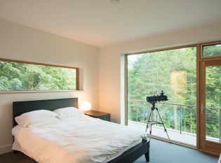 Bedroom connected to cable railing deck.