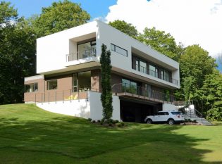 Energy efficient cube house with cable railing system. 