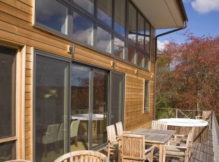 Cable railing waterfront deck with hot tub.