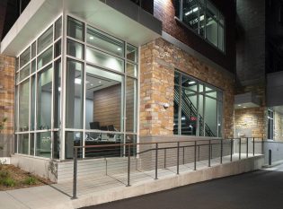 Cable railing system for bank entrance ramp.