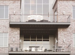 Cable railing decks on bank exterior.