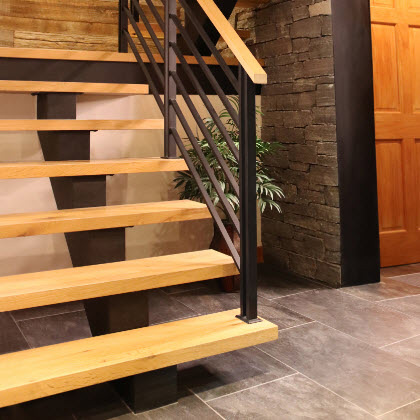 Floating staircase with a flat bar railing