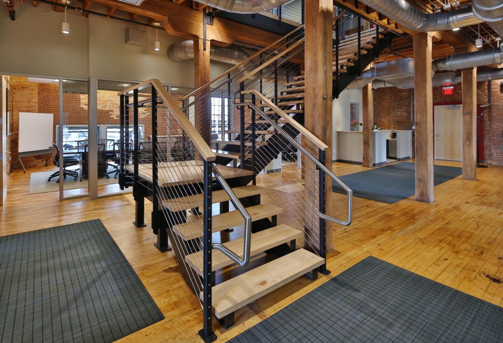 Industrial style cable railing for office staircase