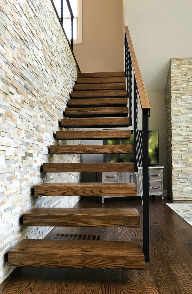 Floating stair treads against stone wall. Treads are Red Oak with Steel stringer structure.