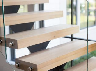 Staircase with white oak treads and glass railing