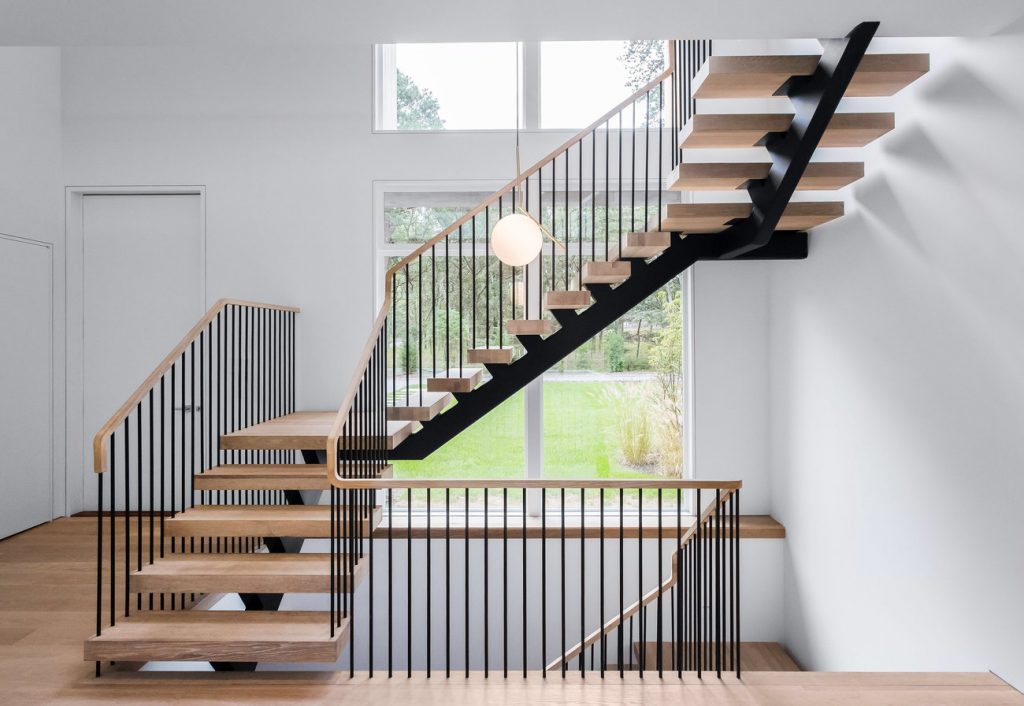Open floating staircase allows natural light through the spindles is one example to understand how much stairs cost