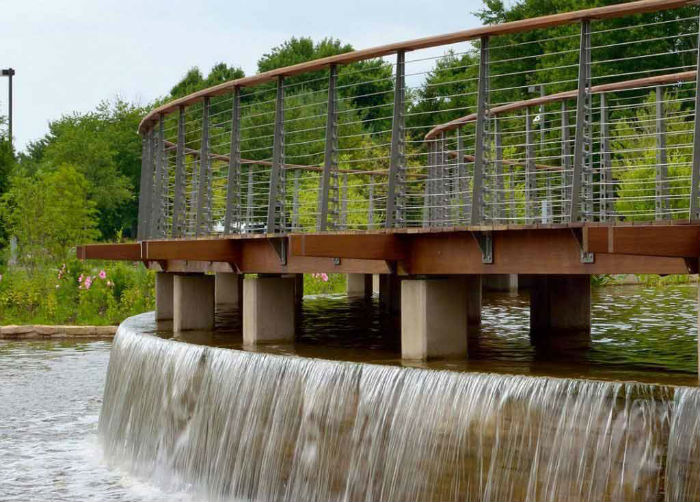 Curved deck bridge railing in our Chicago style with industrial styling