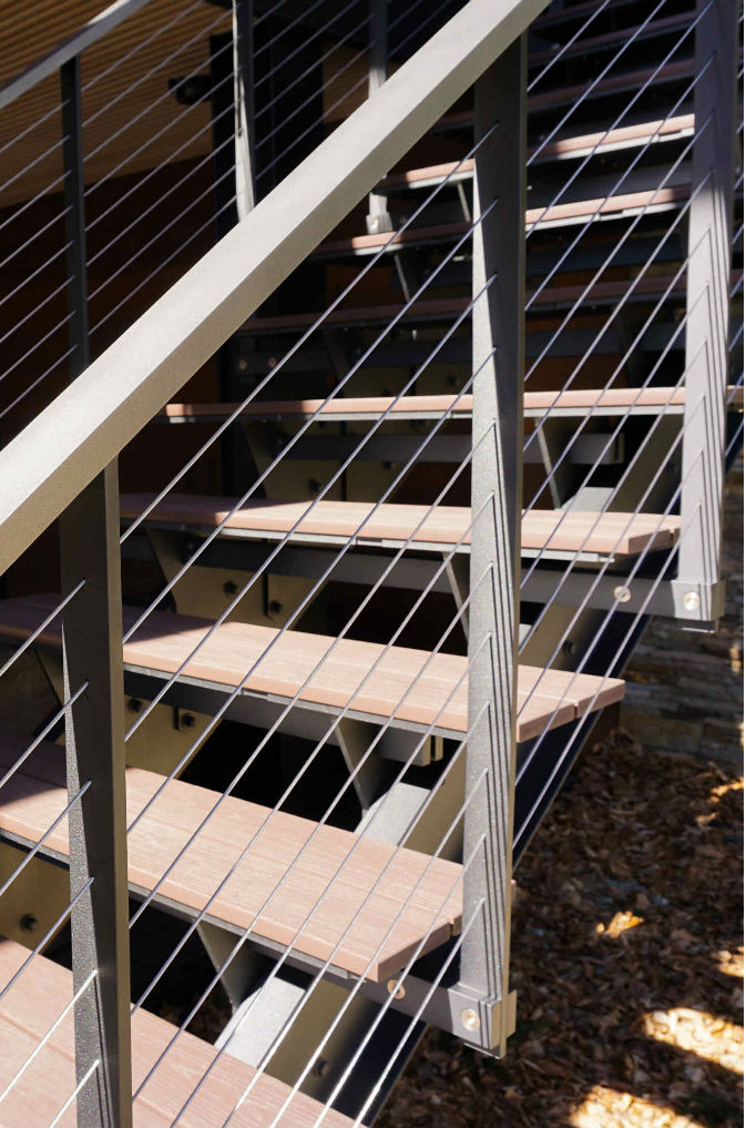 Composite treads on floating cable railing staircase.