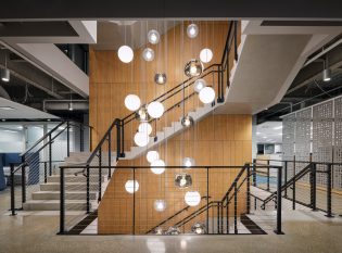 Multi-level lobby staircase with Keuka Studios Ithaca Style cable railing system