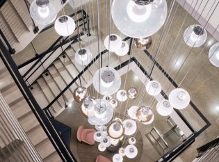 Lobby staircase with cable railings as seen from the top floor.