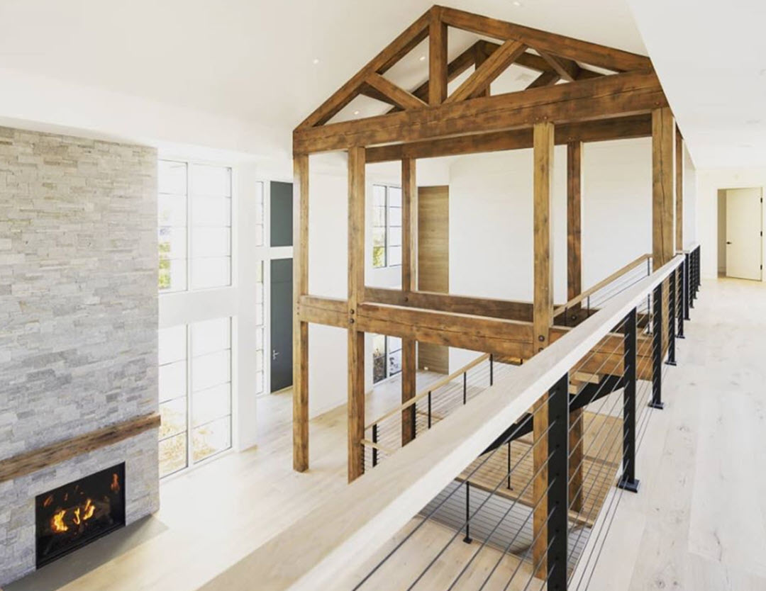 Rustic modern farm house with timber frame and black cable railing system on balcony and stairs