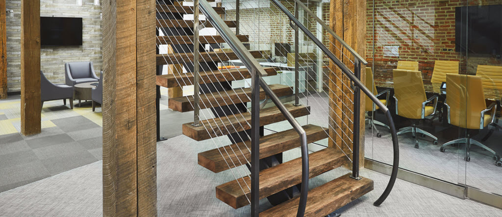 ADA handrail on rustic floating stairs made of steel with wood treads